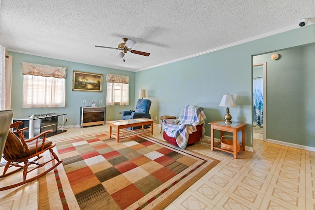 rec room featuring crown molding, ceiling fan, and a textured ceiling