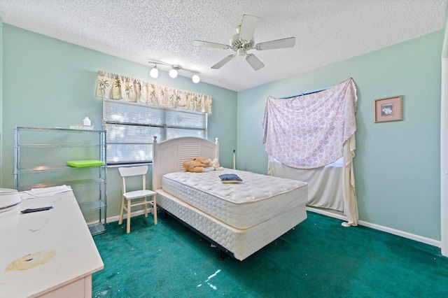 carpeted bedroom with ceiling fan and a textured ceiling