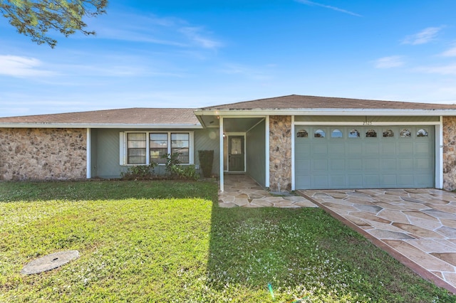 ranch-style house featuring a garage and a front yard