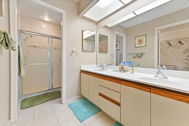 bathroom with tile patterned flooring, vanity, and an enclosed shower