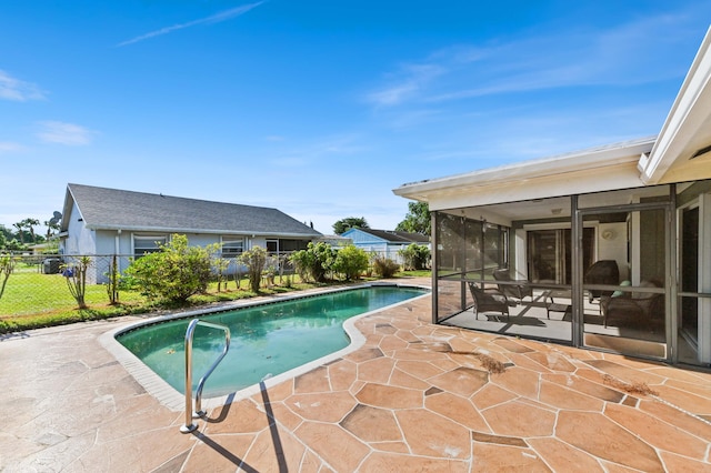 view of pool with a patio and a sunroom