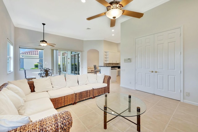 tiled living room featuring ceiling fan and ornamental molding