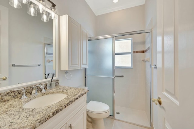 bathroom featuring tile patterned flooring, a shower with door, vanity, and toilet