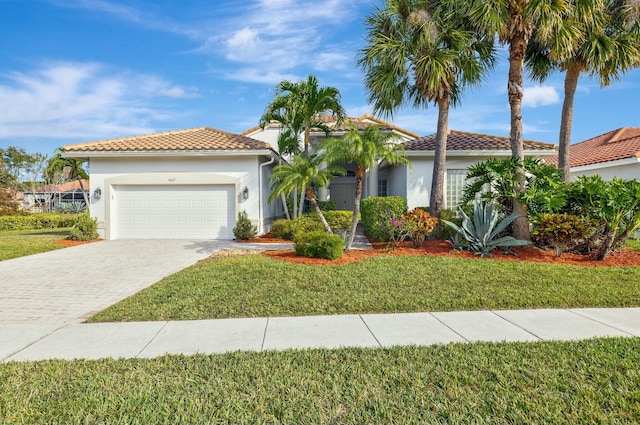 mediterranean / spanish-style home with a garage and a front yard