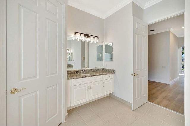 bathroom featuring vanity, tile patterned floors, and ornamental molding