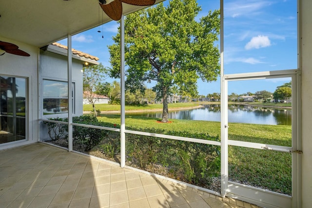 unfurnished sunroom featuring a water view