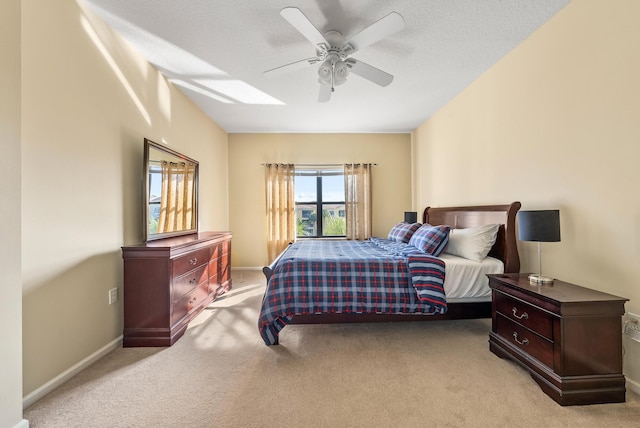 bedroom with light carpet, a textured ceiling, and ceiling fan