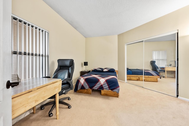 bedroom with a closet, carpet, and a textured ceiling