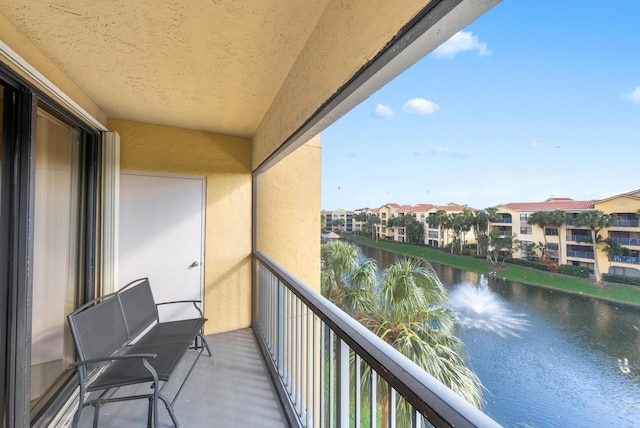 balcony featuring a water view