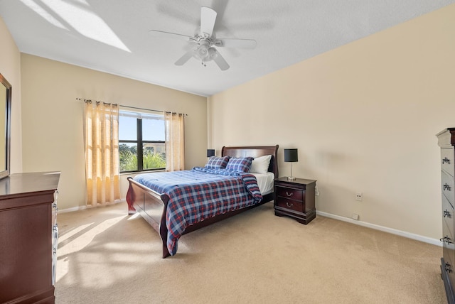 carpeted bedroom with a textured ceiling and ceiling fan