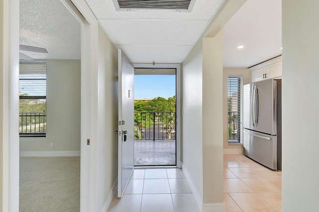 entryway featuring light tile patterned floors and a healthy amount of sunlight