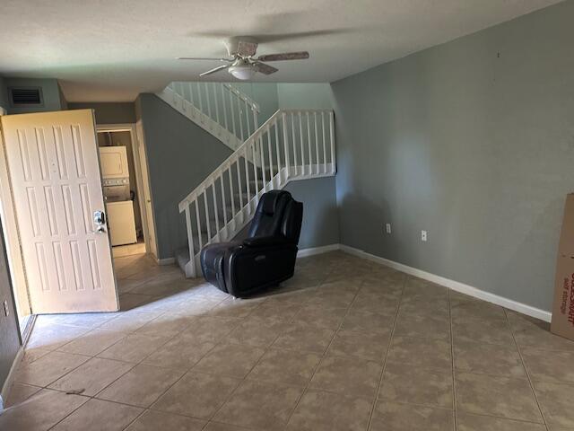 unfurnished living room with ceiling fan