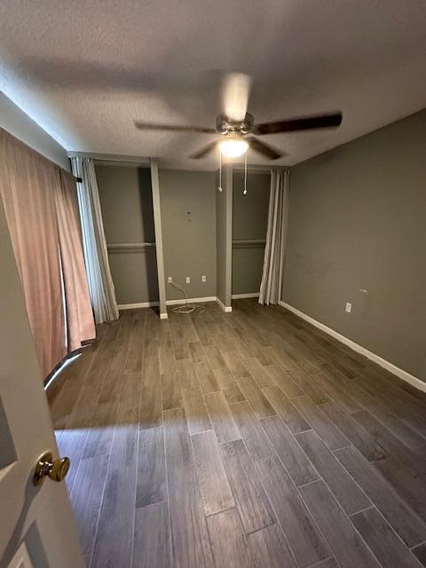 unfurnished bedroom with ceiling fan, a textured ceiling, and hardwood / wood-style flooring