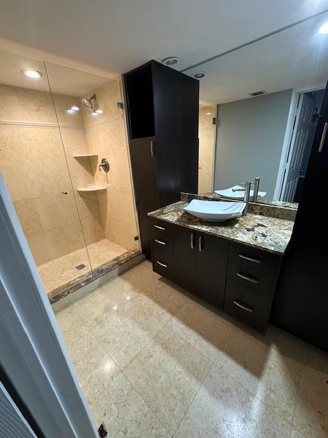 bathroom featuring vanity and an enclosed shower