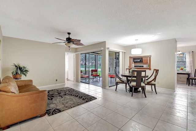 tiled living room featuring a textured ceiling and ceiling fan