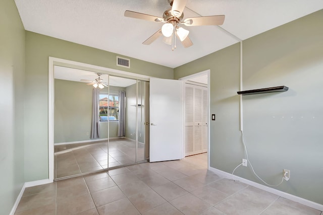 unfurnished bedroom with ceiling fan and light tile patterned floors