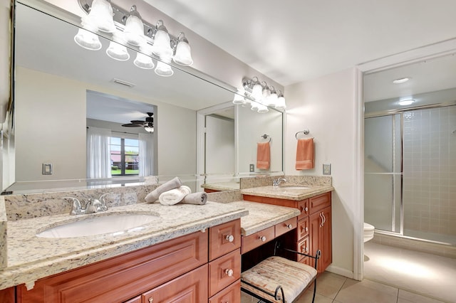 bathroom featuring vanity, tile patterned floors, ceiling fan, toilet, and walk in shower