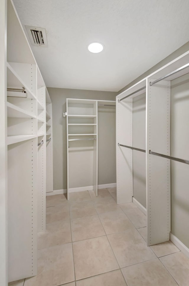 walk in closet featuring light tile patterned flooring