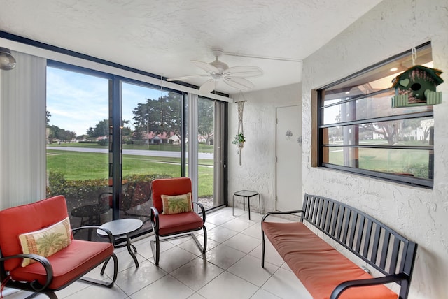 sunroom / solarium featuring ceiling fan