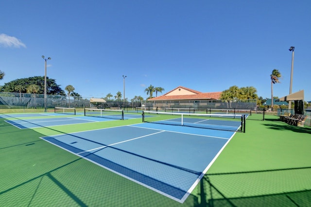 view of tennis court with basketball hoop