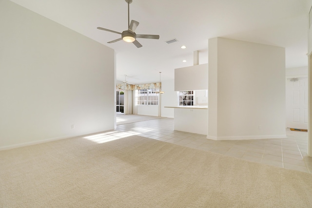 unfurnished living room featuring light tile patterned floors and ceiling fan with notable chandelier