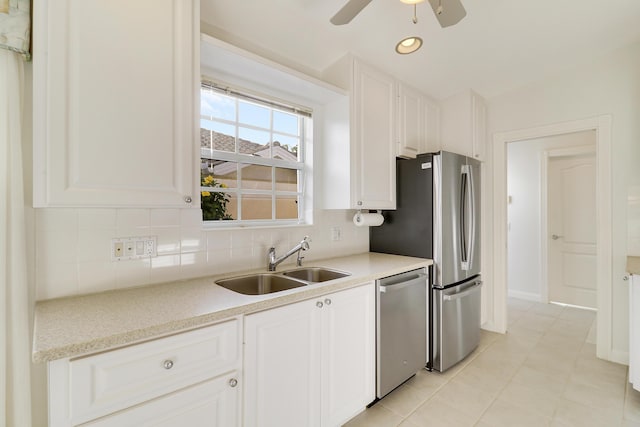 kitchen with backsplash, white cabinetry, stainless steel dishwasher, and sink