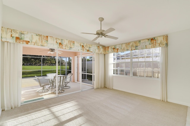 interior space featuring carpet flooring, ceiling fan, and vaulted ceiling