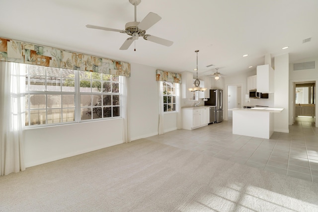 unfurnished living room featuring light carpet, vaulted ceiling, ceiling fan, and sink