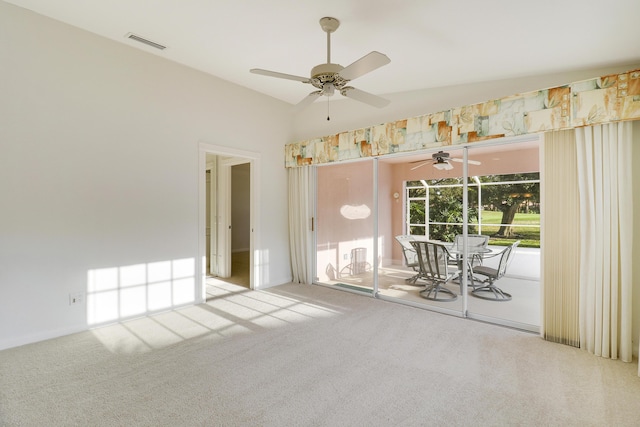 carpeted spare room with vaulted ceiling and ceiling fan