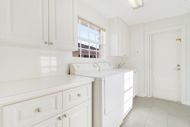 washroom with separate washer and dryer, sink, light tile patterned flooring, and cabinets