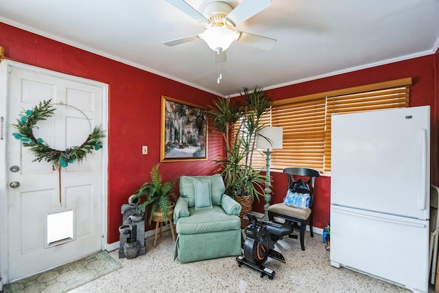 sitting room featuring ceiling fan and crown molding