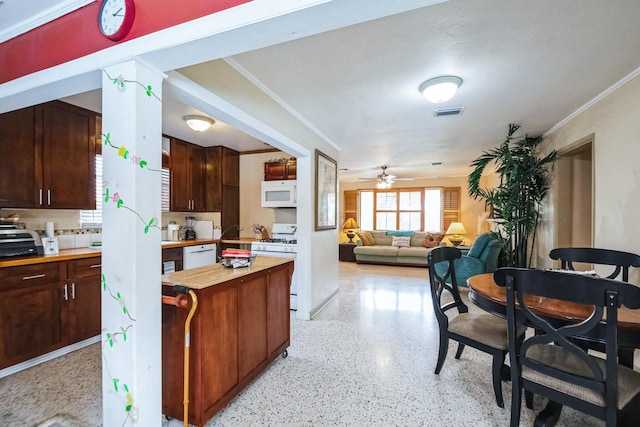 kitchen with white appliances, crown molding, ceiling fan, and butcher block counters