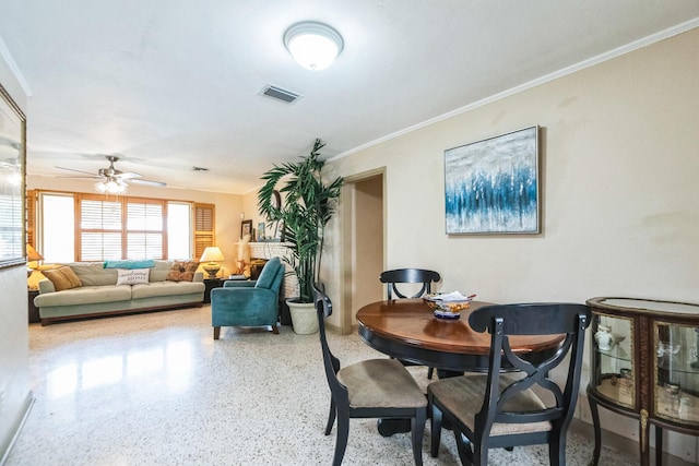 dining space featuring ceiling fan and ornamental molding