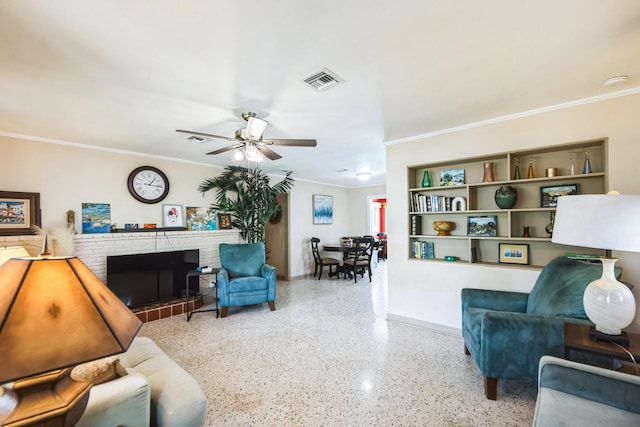 living room featuring built in shelves, ceiling fan, a fireplace, and ornamental molding