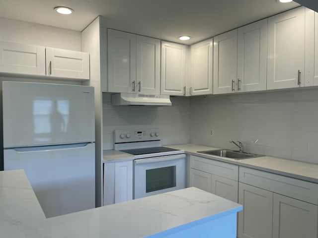 kitchen featuring white appliances, sink, and white cabinets