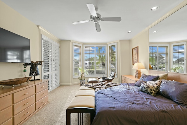 carpeted bedroom with multiple windows and ceiling fan