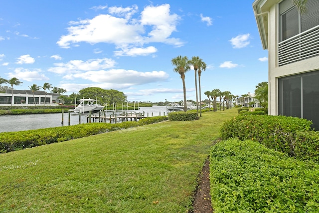 view of yard with a dock and a water view