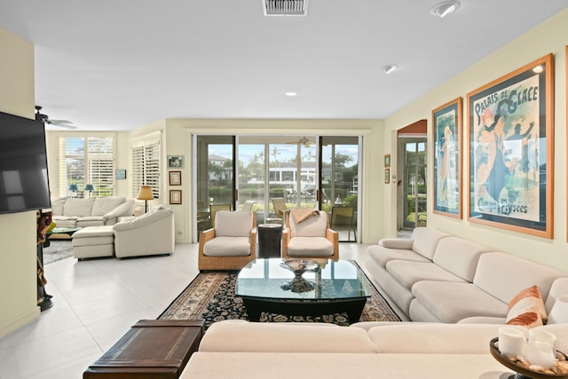 tiled living room with ceiling fan