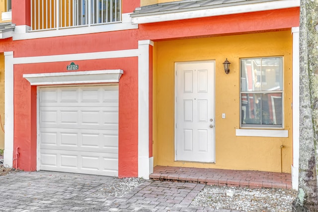 view of exterior entry featuring a garage