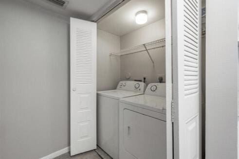 clothes washing area with separate washer and dryer