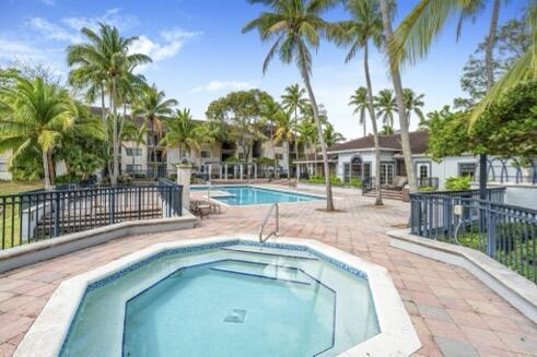 view of swimming pool with a patio area and a community hot tub