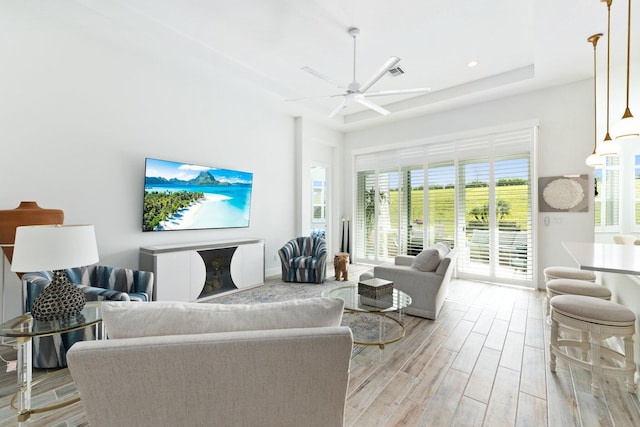 living room featuring ceiling fan and light hardwood / wood-style floors