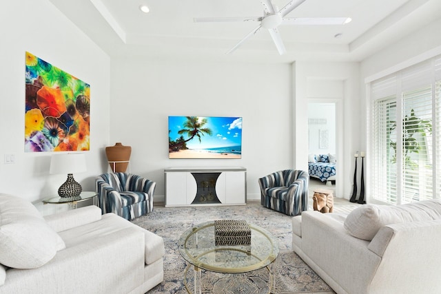 9289 SW Miracoli Way, Port Saint Lucie, FL 34987 - living room featuring a ceiling fan, recessed lighting, a tray ceiling, and baseboards