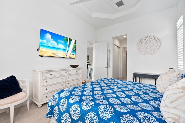 carpeted bedroom featuring ceiling fan and a raised ceiling