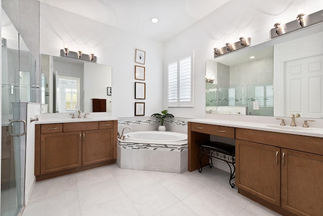 9289 SW Miracoli Way, Port Saint Lucie, FL 34987 - bathroom with healthy amount of natural light, two vanities, a stall shower, and recessed lighting