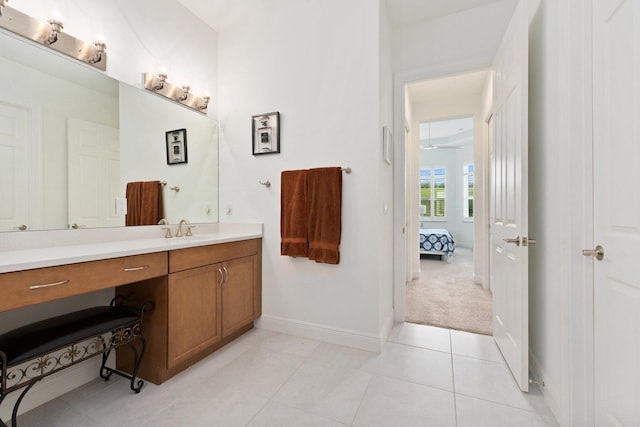 9289 SW Miracoli Way, Port Saint Lucie, FL 34987 - bathroom featuring vanity, connected bathroom, baseboards, and tile patterned flooring