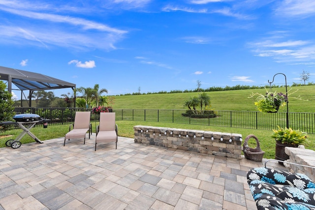 view of patio / terrace featuring a rural view and a lanai