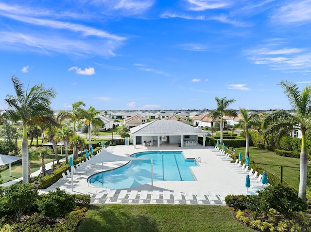 9289 SW Miracoli Way, Port Saint Lucie, FL 34987 - community pool featuring a patio, a yard, and a residential view