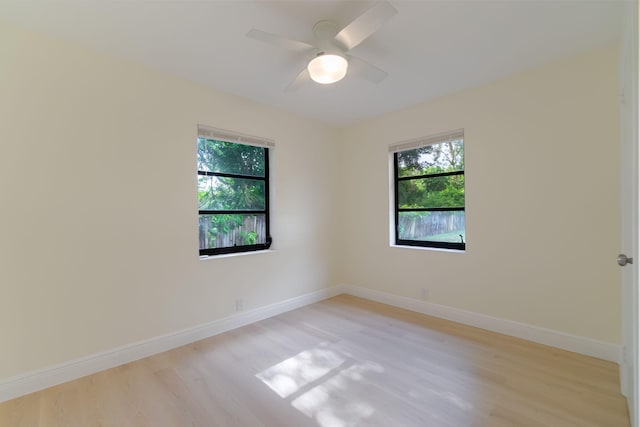 empty room with light hardwood / wood-style flooring, plenty of natural light, and ceiling fan