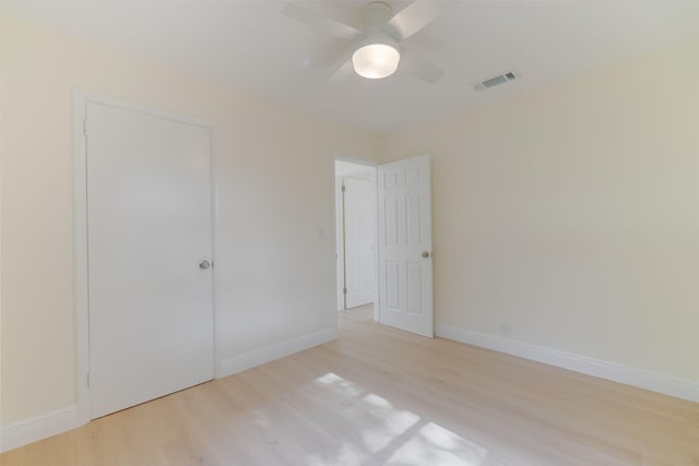 unfurnished bedroom with ceiling fan, a closet, and light hardwood / wood-style floors